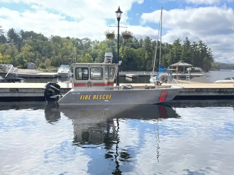 The Lake Rosseau Fire Rescue Boat tied to a dock at a marina.
