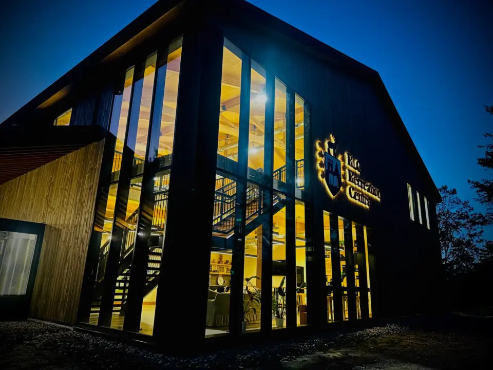 The Rosseau Lake College Sports Complex building at night.